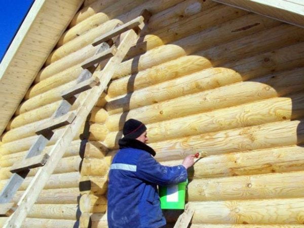 A man paints the exterior of the bath