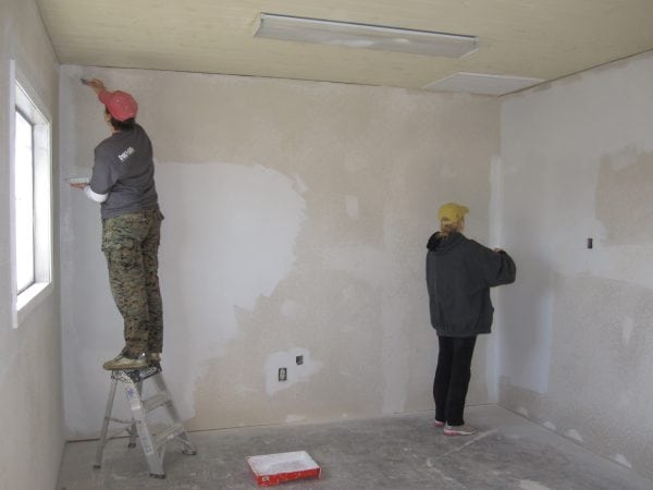 Workers prepare the walls