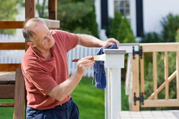 Painting the fence with white paint