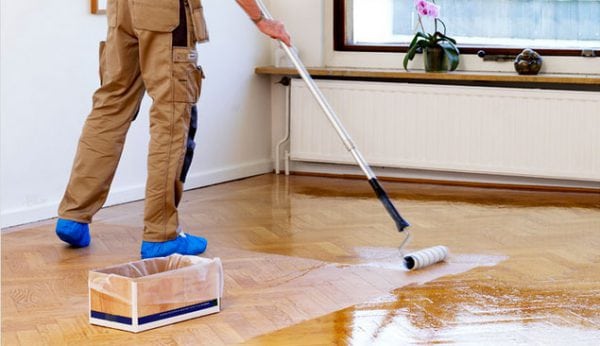 Varnishing the floor with a roller