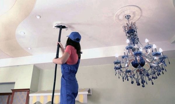 Washing the ceiling on a stepladder