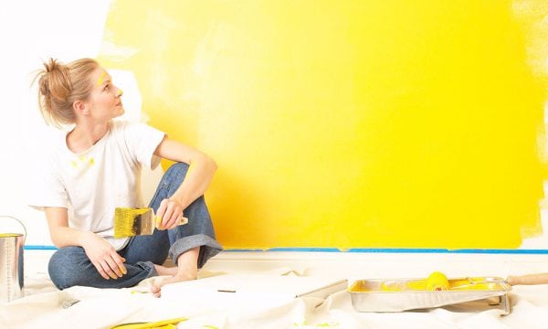 Painting the wall with yellow paint