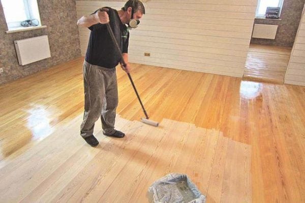 Applying varnish to the floor in a respirator