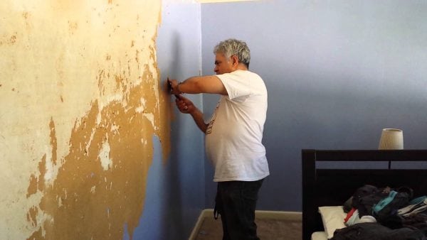 Peeling paint should be removed from the wall.