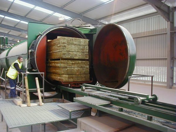 Impregnation of lumber in a vacuum chamber