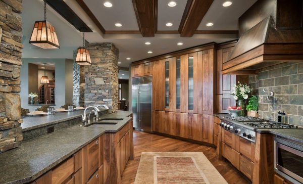 The use of wood and natural stone in the design of the kitchen in a modern style