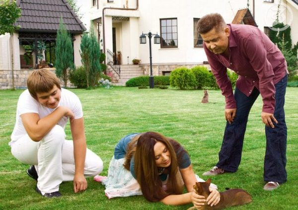 With wife and son on the front lawn