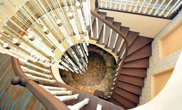 Hallway with stairs and chandelier