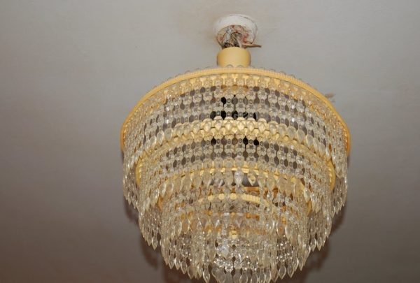 A yellowed plastic chandelier gives the room a miserable look