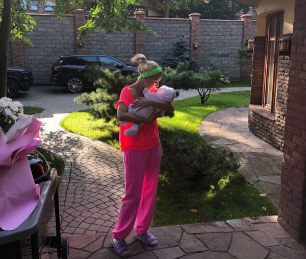 Lera Kudryavtseva in the courtyard of her country house